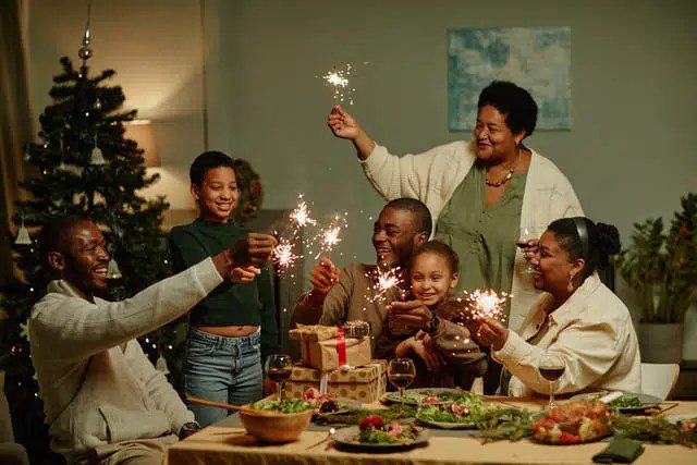 Family Together Celebrating Christmas with Sparklers and Presents